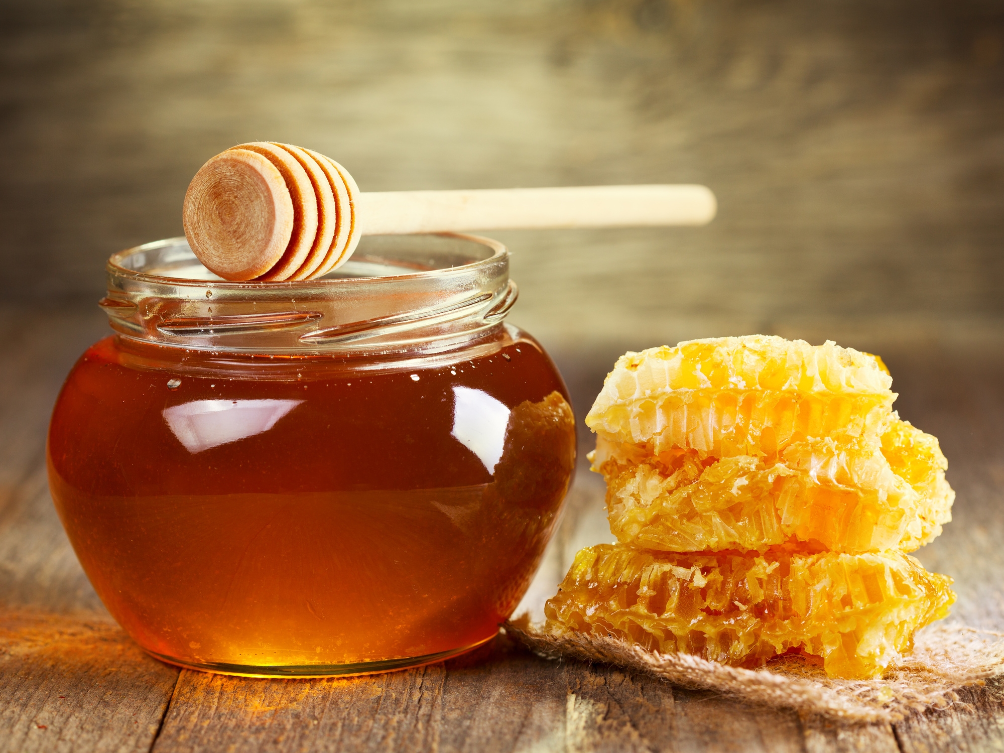 jar of honey with honeycomb